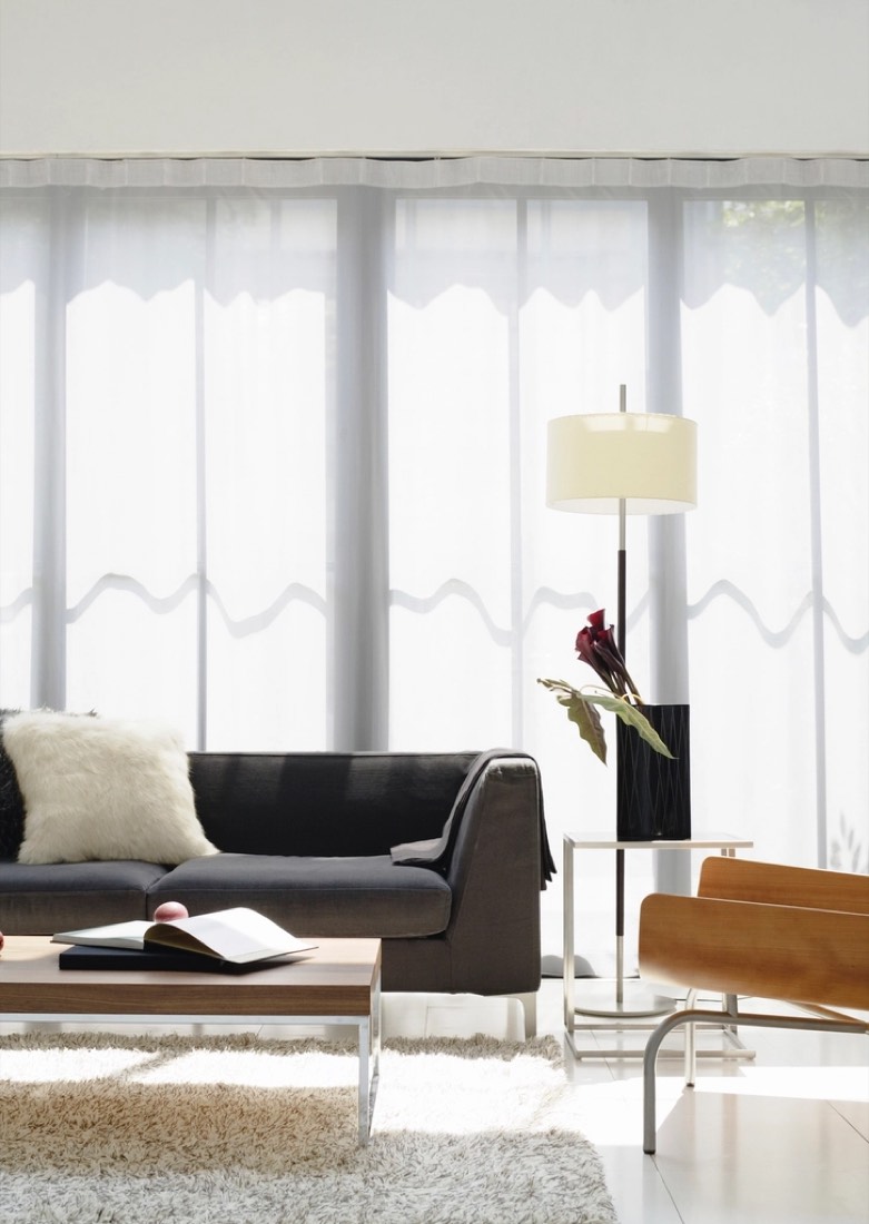 Bright, freshly finished living space with curtains, a lamp, and a healthy plant, ready to move in